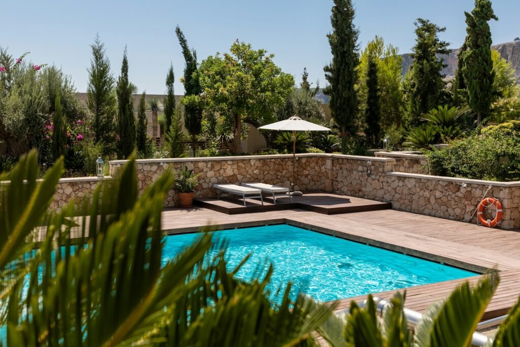 Outdoor swimming pool surrounded by landscaping